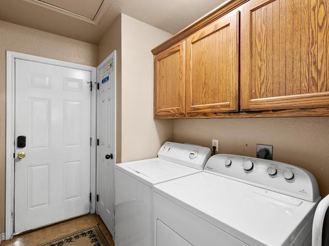 792 County Road 4213 Decatur, TX 76234 - Photo 13 of 32 Washroom with washing machine and dryer, cabinet space, and tile patterned floors