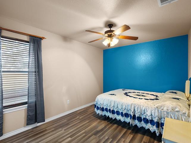 792 County Road 4213 Decatur, TX 76234 - Photo 15 of 32 Bedroom featuring wood finished floors, a ceiling fan, and a textured ceiling