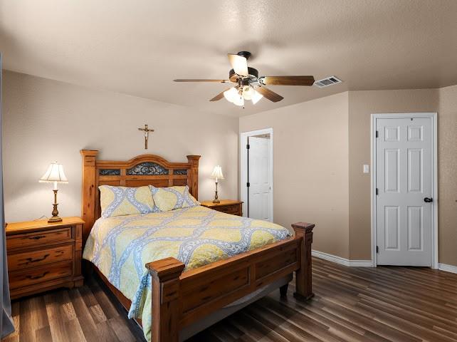 792 County Road 4213 Decatur, TX 76234 - Photo 17 of 32 Bedroom with dark wood finished floors and a ceiling fan