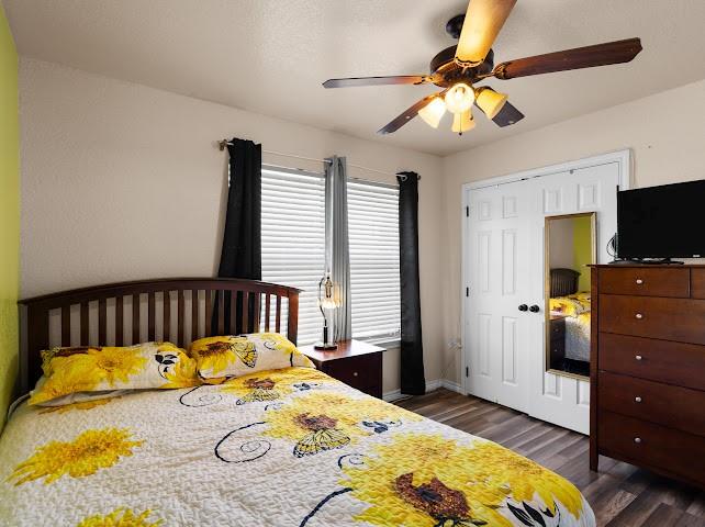 792 County Road 4213 Decatur, TX 76234 - Photo 23 of 32 Bedroom featuring dark wood finished floors, ceiling fan, and a textured ceiling