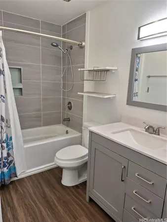 a bathroom with a sink toilet a mirror and shower
