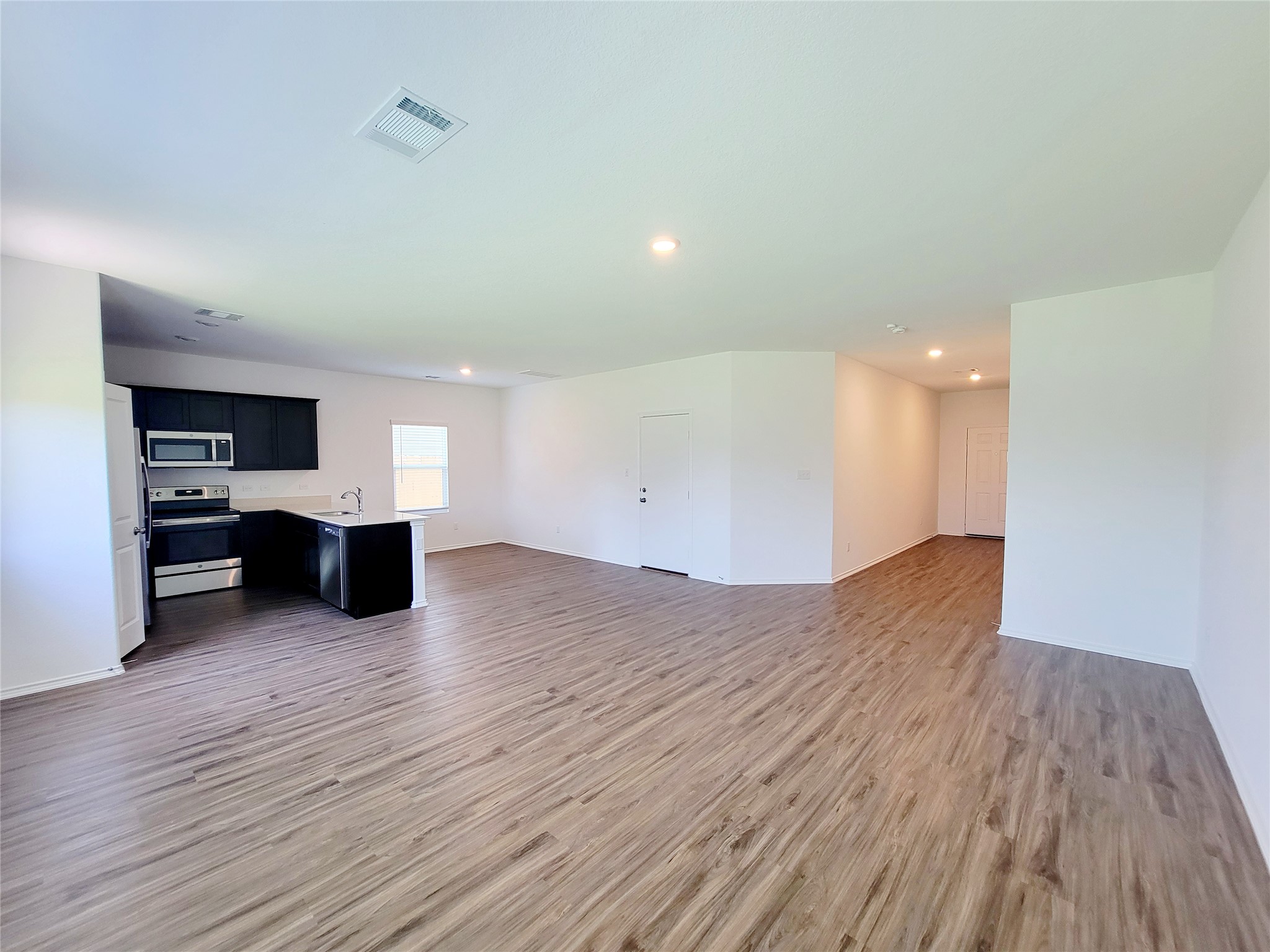 309 Bullhead Road Bastrop, TX 78602 - Photo 3 of 8 Unfurnished living room featuring recessed lighting and light wood finished floors