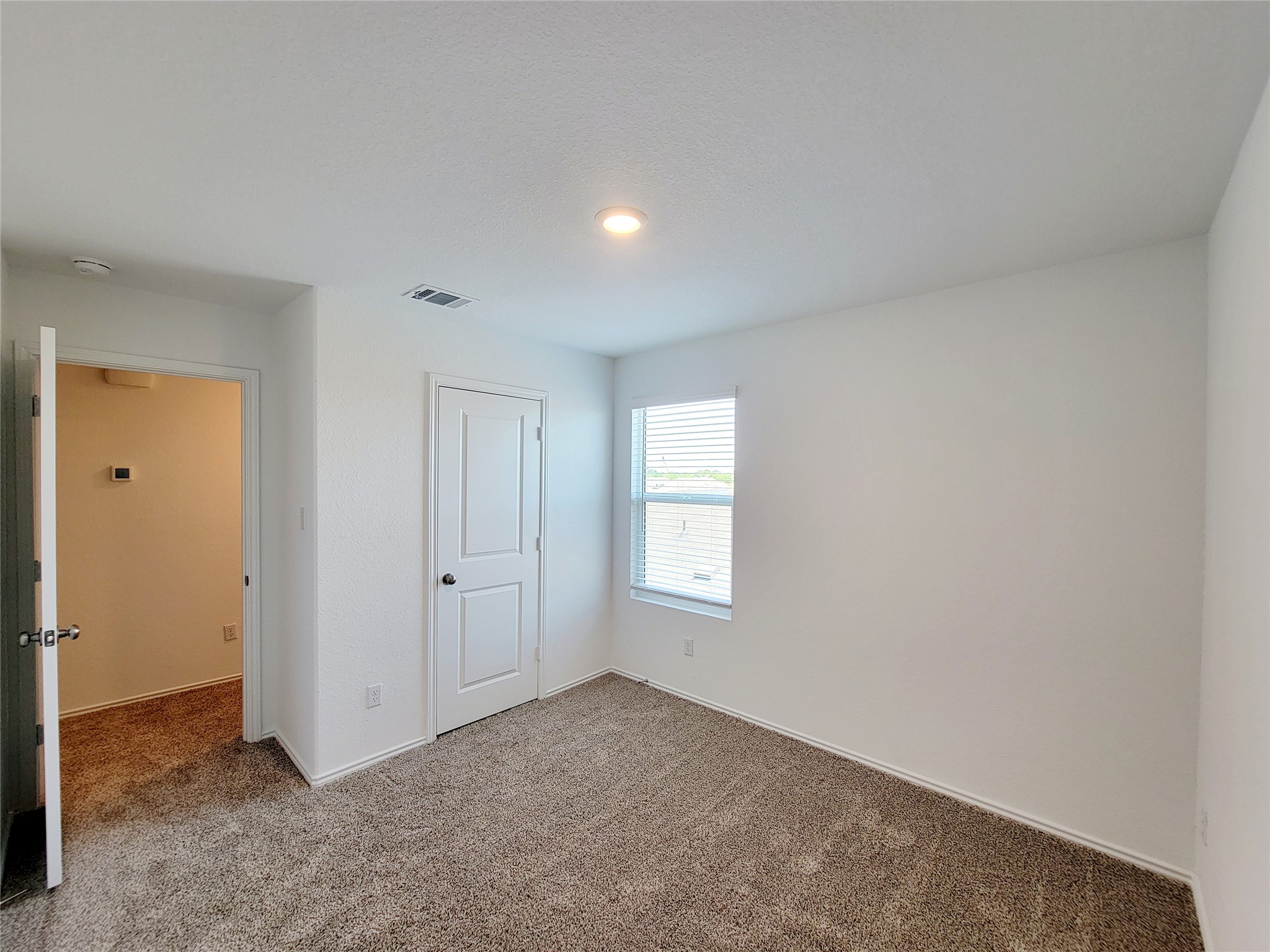 309 Bullhead Road Bastrop, TX 78602 - Photo 5 of 8 Unfurnished bedroom with dark carpet and a closet