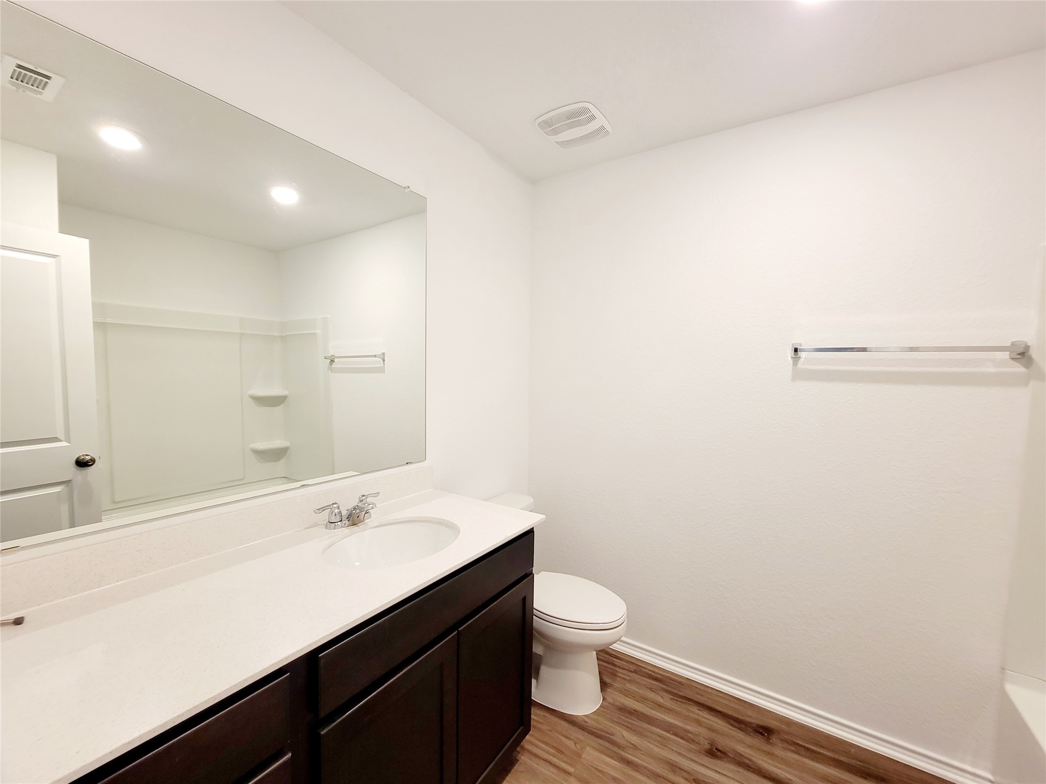 309 Bullhead Road Bastrop, TX 78602 - Photo 6 of 8 Bathroom with vanity, light wood-style floors, recessed lighting, a shower, and a tub