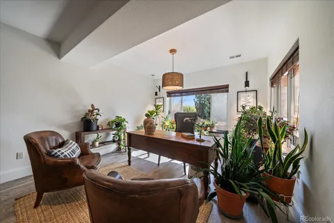a view of a dining room with furniture and a potted plant
