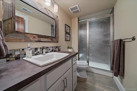 a view of a patio with couches table and chairs and potted plants