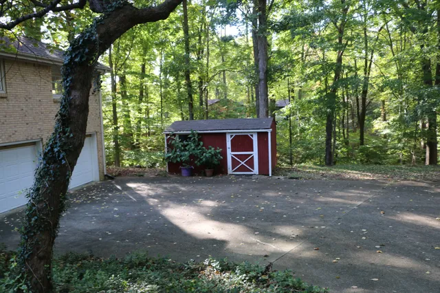 a view of a house with a tree next to a yard
