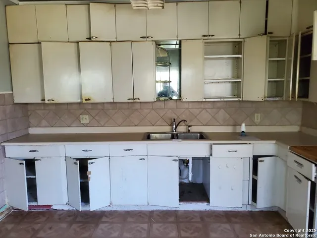 a view of cabinets with stainless steel appliances wooden floor