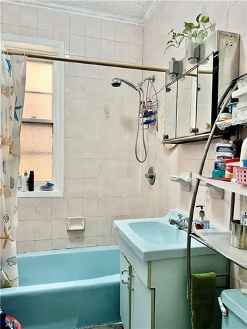 a bathroom with a sink mirror and a bathtub