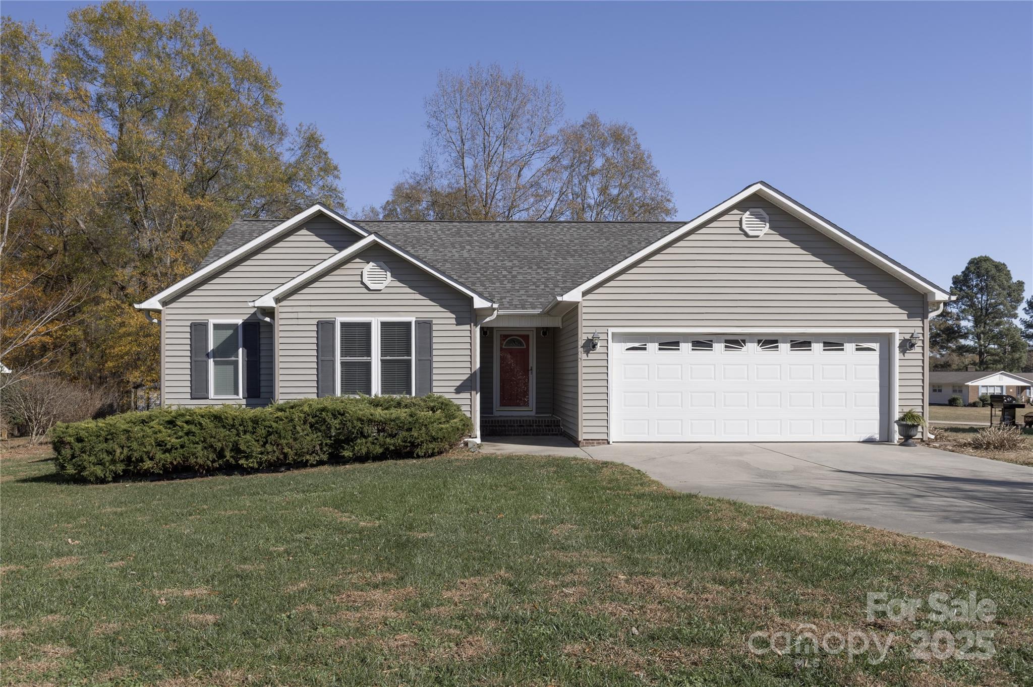 a view of a house with a yard and garage