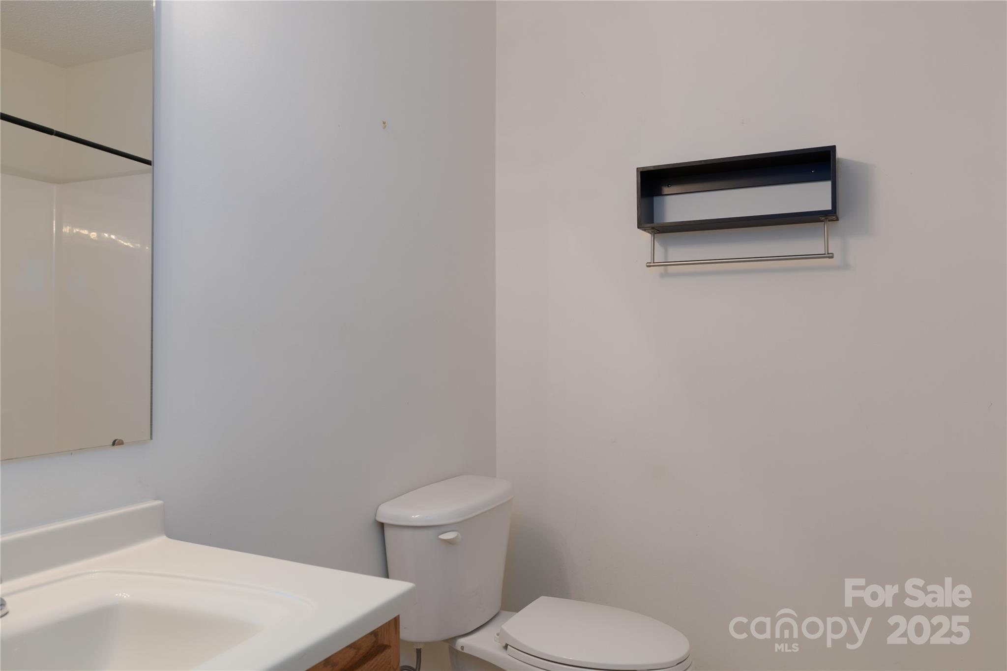1505 Moss Springs Road Albemarle, NC 28001 - Photo 14 of 26 a white toilet sitting next to a white sink and vanity