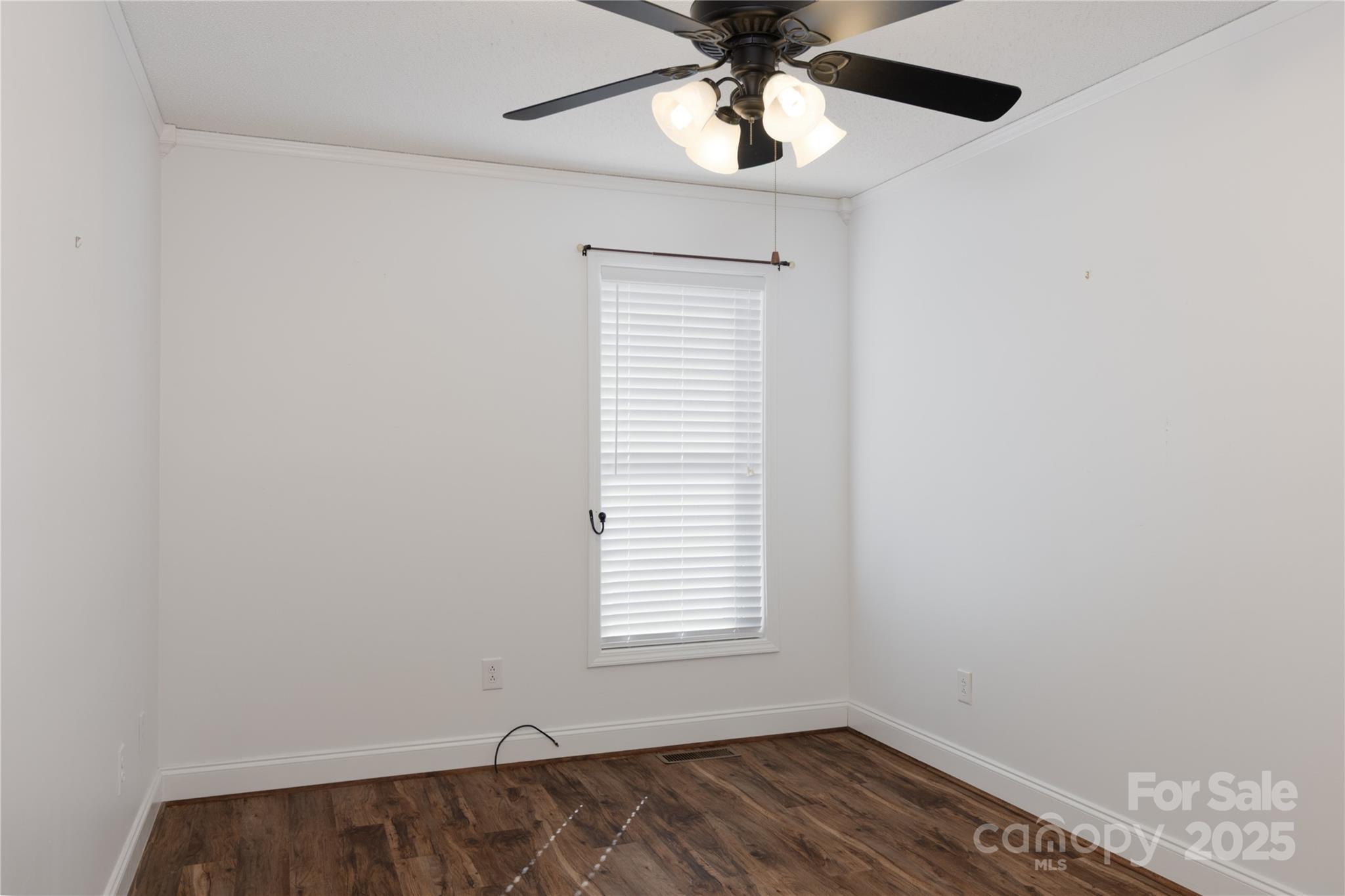 1505 Moss Springs Road Albemarle, NC 28001 - Photo 15 of 26 an empty room with a window and a ceiling fan