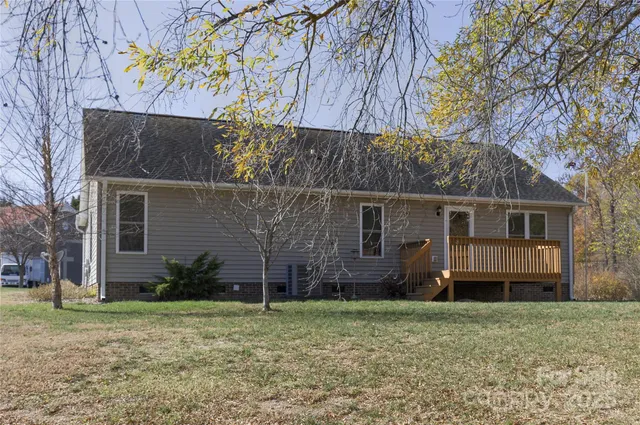 a view of backyard with wooden fence
