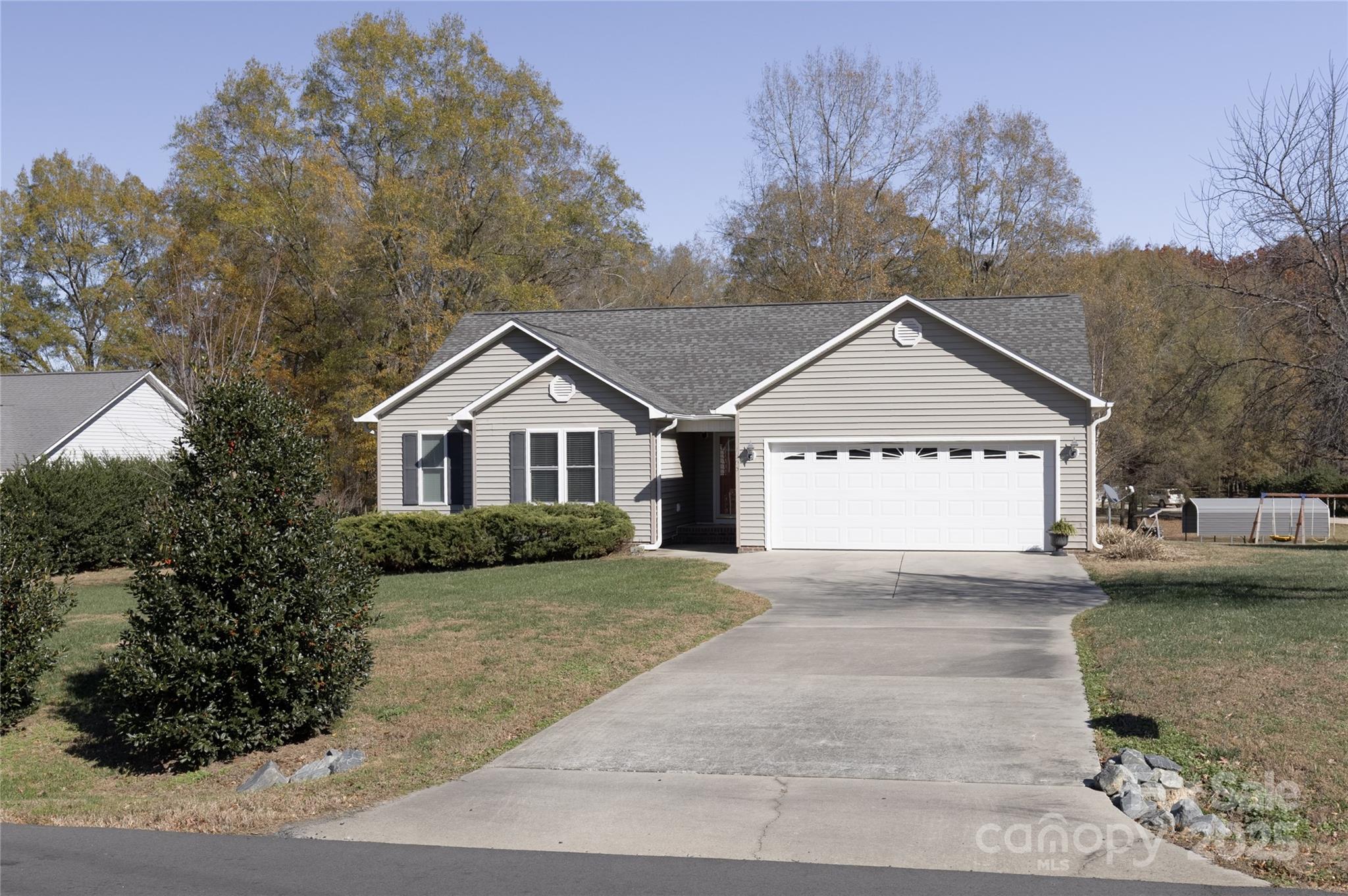 1505 Moss Springs Road Albemarle, NC 28001 - Photo 25 of 26 a view of a house with a yard and garage