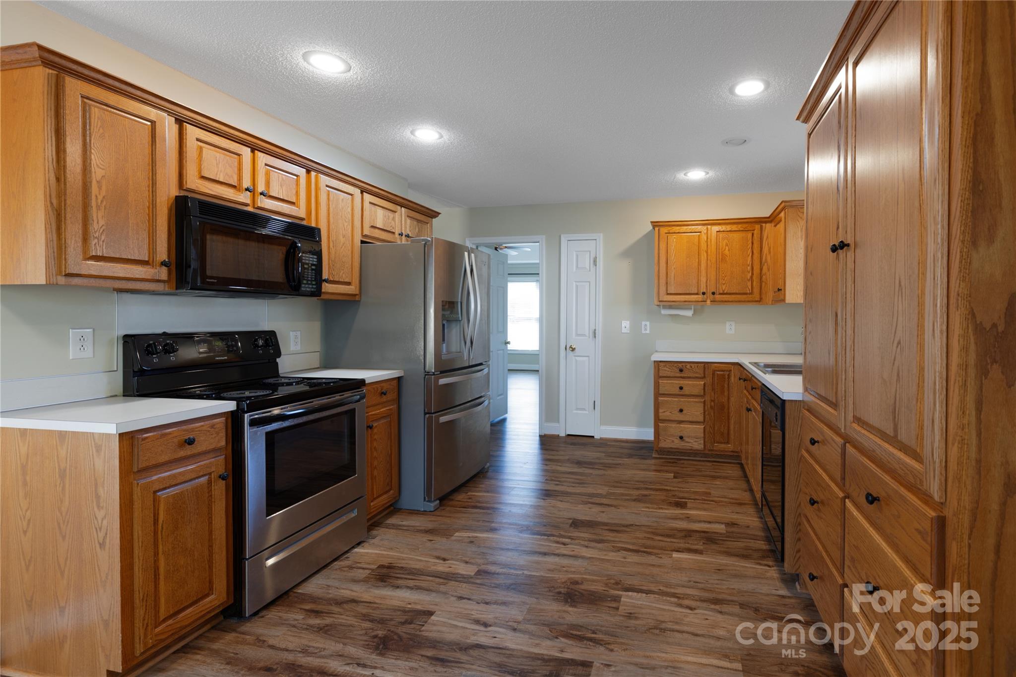 1505 Moss Springs Road Albemarle, NC 28001 - Photo 6 of 26 a kitchen with stainless steel appliances granite countertop a stove a sink and a refrigerator