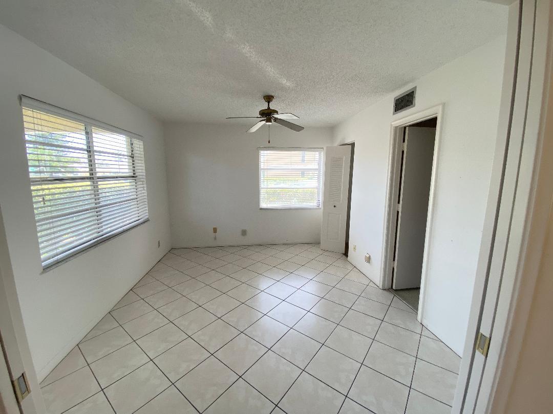 1141 Violet Terrace, Unit 101 Delray Beach, FL 33445 - Photo 12 of 29 an empty room with windows