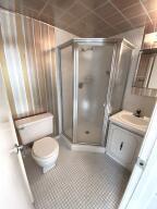 1141 Violet Terrace, Unit 101 Delray Beach, FL 33445 - Photo 14 of 29 a bathroom with a granite countertop sink toilet and shower