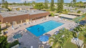 1141 Violet Terrace, Unit 101 Delray Beach, FL 33445 - Photo 16 of 29 a view of a swimming pool with a patio