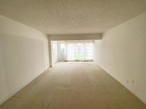 1141 Violet Terrace, Unit 101 Delray Beach, FL 33445 - Photo 6 of 29 a view of an empty room with a window