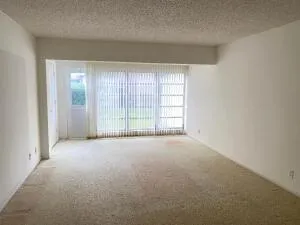 an empty room with windows and entrance