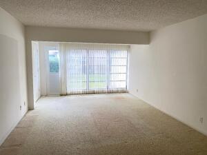 1141 Violet Terrace, Unit 101 Delray Beach, FL 33445 - Photo 7 of 29 an empty room with windows and entrance