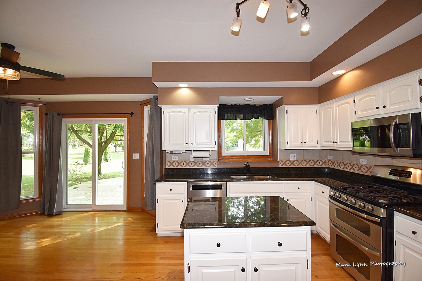 548 Lewis Road Geneva, IL 60134 - Photo 13 of 47 a kitchen with stainless steel appliances granite countertop a stove a sink and a microwave