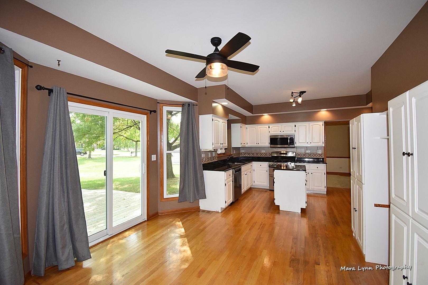 548 Lewis Road Geneva, IL 60134 - Photo 17 of 47 a open kitchen with stainless steel appliances granite countertop a refrigerator a stove a sink dishwasher and a refrigerator with wooden floor