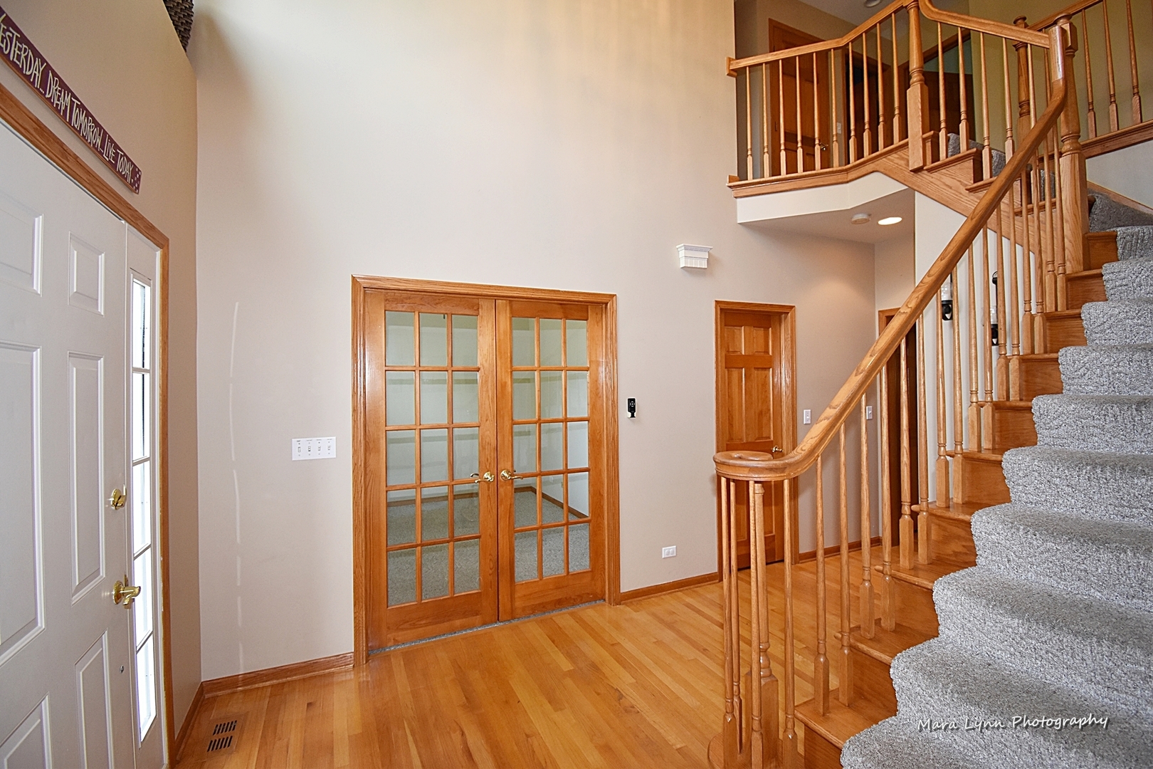 548 Lewis Road Geneva, IL 60134 - Photo 5 of 47 a view of staircase with lots of frames on wall and a window