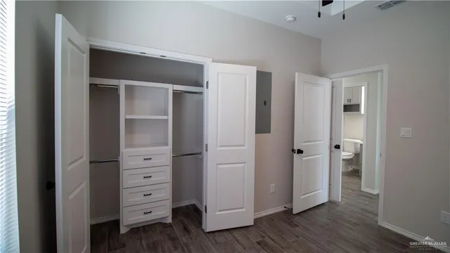 a view of closet with wooden floor