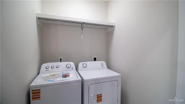 a view of storage and utility room with washer and dryer