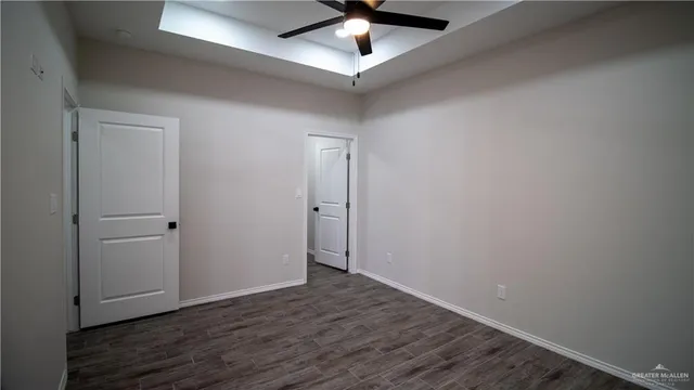 a view of an empty room with wooden floor