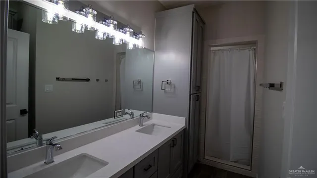 a bathroom with a sink vanity and a mirror