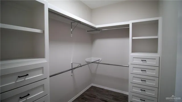 a view of walk in closet with empty racks