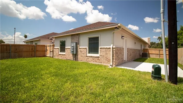 a view of a house with backyard and porch
