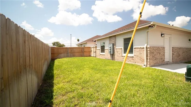 a backyard of a house with table and chairs