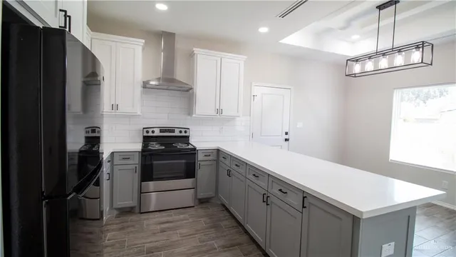 a kitchen with stainless steel appliances a stove and a refrigerator