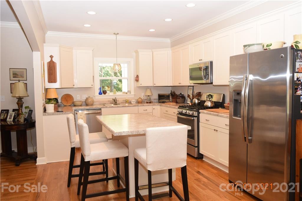 160 Kent Road Salisbury, NC 28147 - Photo 11 of 27 a kitchen with stainless steel appliances granite countertop a dining table chairs refrigerator sink and cabinets