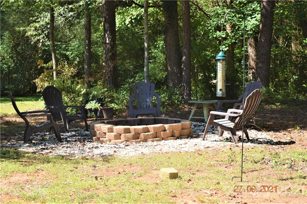 160 Kent Road Salisbury, NC 28147 - Photo 23 of 27 a view of a swimming pool with chairs and wooden fence