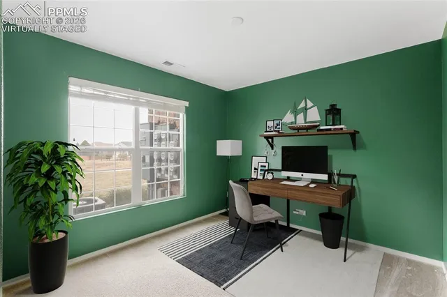 a view of an empty room with windows & cabinet
