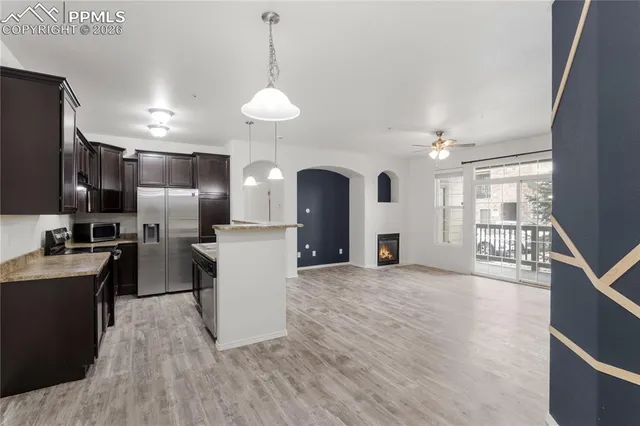 a kitchen with stainless steel appliances granite countertop a sink a stove and a refrigerator