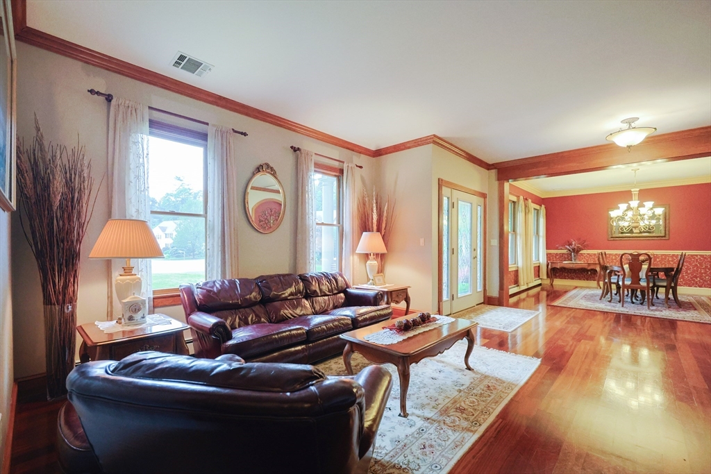 70 Azalea Way Hanson, MA 02341 - Photo 10 of 42 a living room with furniture a window and a lamp