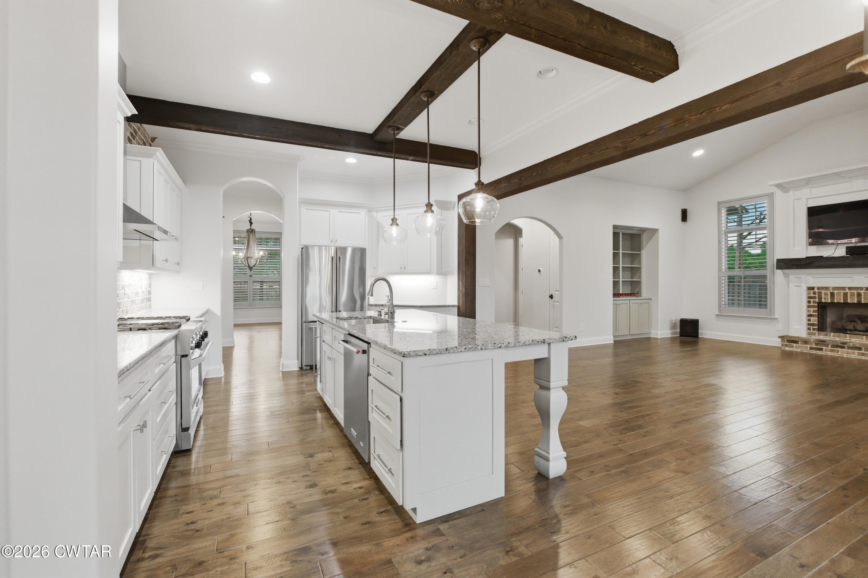 963 Ashport Road Jackson, TN 38305 - Photo 14 of 60 a large white kitchen with lots of counter space and stainless steel appliances