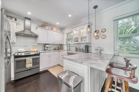 a kitchen with stainless steel appliances granite countertop a stove and a sink