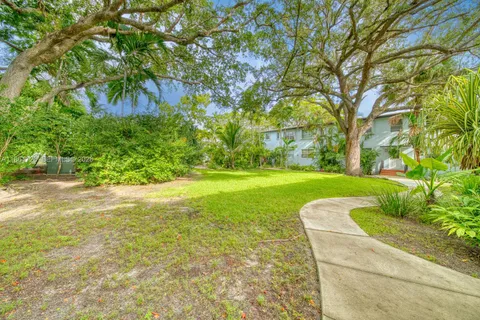 a view of yard with swimming pool and green space