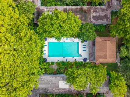 an aerial view of a house with a yard and plants