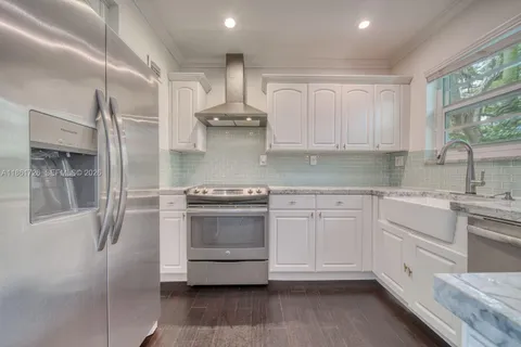 a kitchen with stainless steel appliances a stove sink and refrigerator
