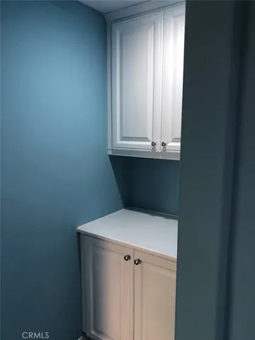 a view of kitchen with white cabinets