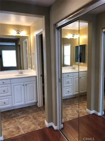 a view of a bathroom with mirror and window