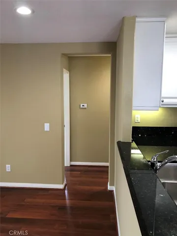 a view of room with wooden floor