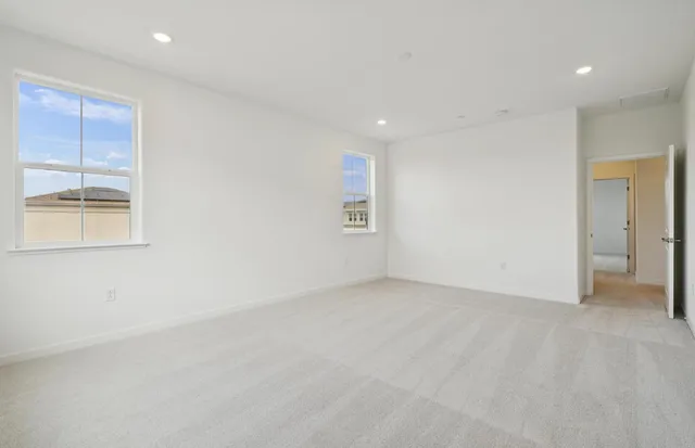 an empty room with windows and closet
